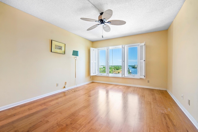 spare room featuring ceiling fan, a textured ceiling, and light wood-type flooring