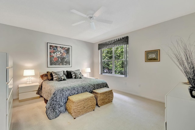 bedroom featuring ceiling fan and light carpet