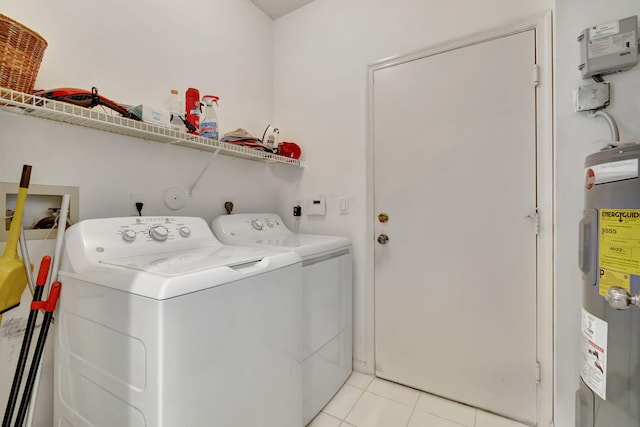 laundry room with washer and clothes dryer, electric water heater, and light tile patterned floors