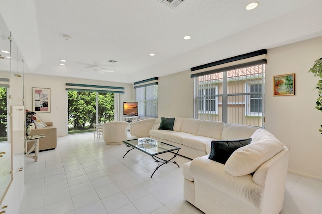 tiled living room with ceiling fan