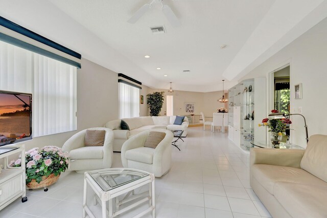 living room with light tile patterned floors and ceiling fan