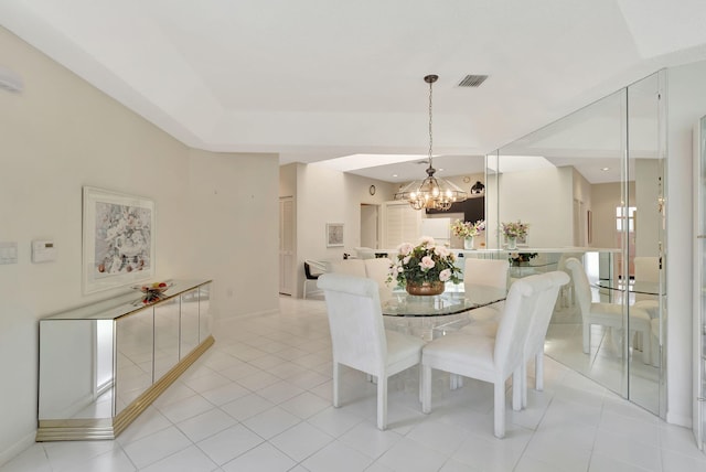 dining area featuring an inviting chandelier and light tile patterned floors