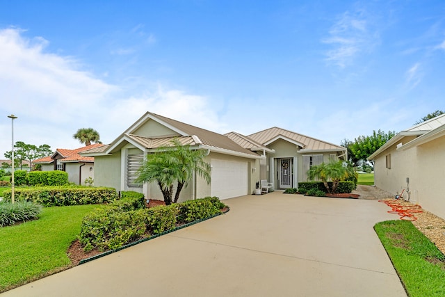 view of front of house featuring a garage and a front lawn