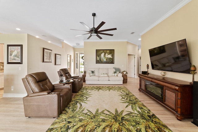 living room with crown molding, ceiling fan, and light hardwood / wood-style floors