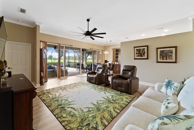 living room with ceiling fan, crown molding, and wood-type flooring