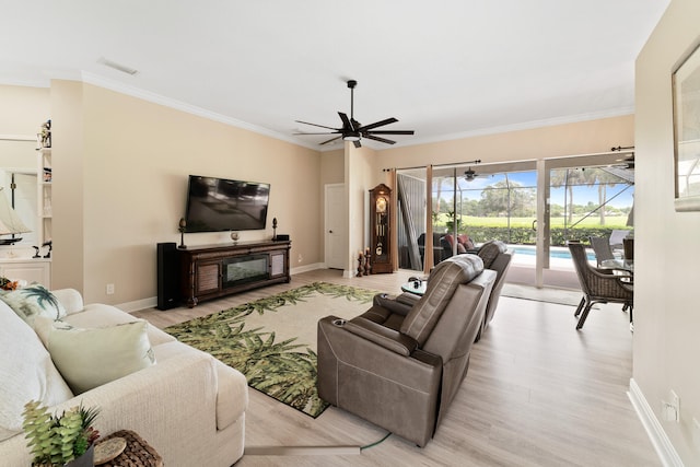 living room with ceiling fan, crown molding, and light hardwood / wood-style flooring