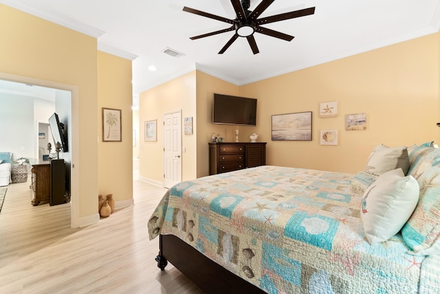bedroom featuring crown molding, light wood-type flooring, ceiling fan, baseboards, and visible vents