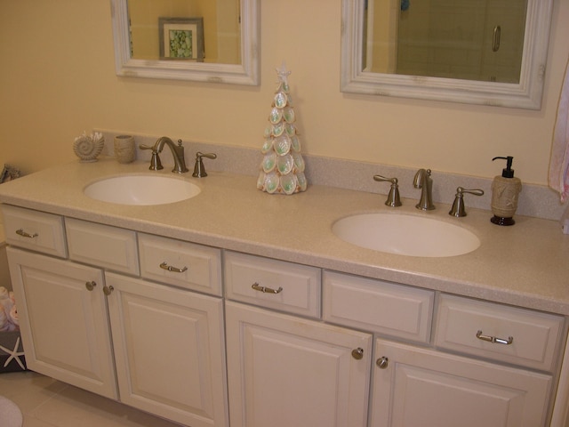 bathroom with tile patterned floors, an enclosed shower, and vanity