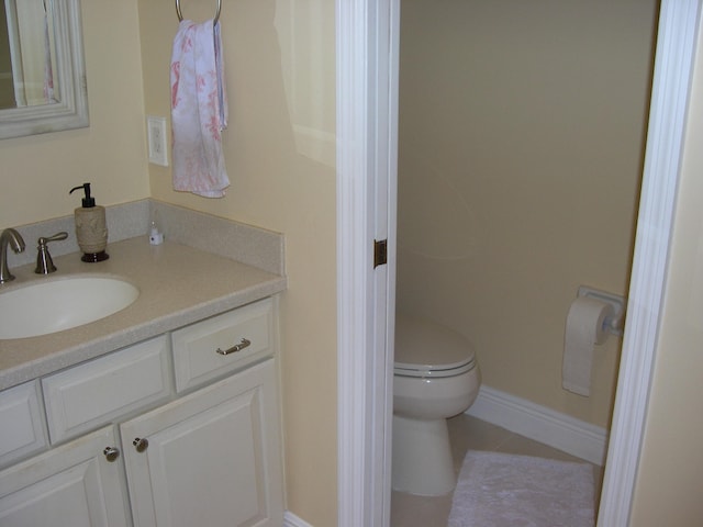 bathroom featuring tile patterned floors, toilet, and vanity