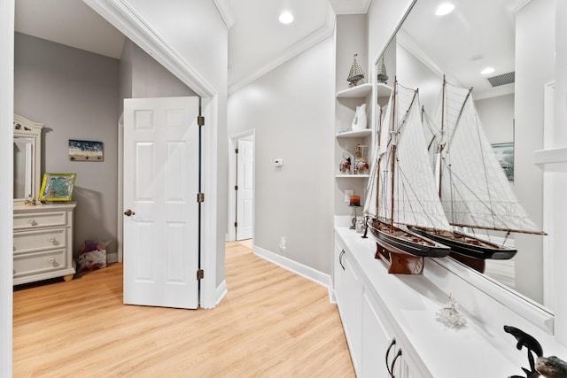 bathroom featuring hardwood / wood-style floors, vanity, and ornamental molding