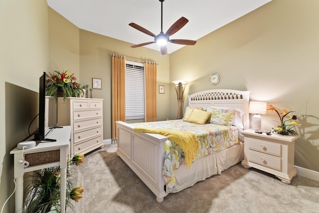 bedroom with light colored carpet, ceiling fan, and baseboards