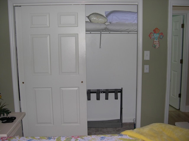 bedroom featuring a closet and baseboards