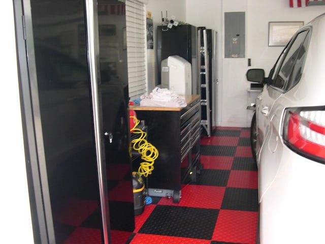 laundry area featuring dark colored carpet and electric panel