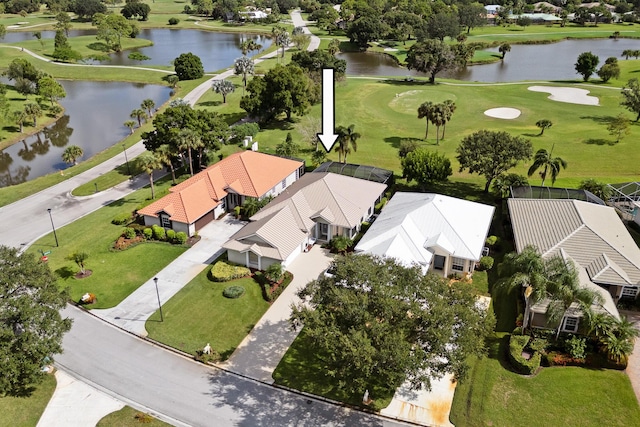 aerial view featuring golf course view, a residential view, and a water view