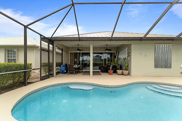 view of swimming pool featuring an outdoor living space, glass enclosure, ceiling fan, and a patio