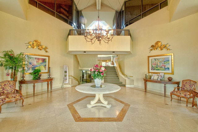 interior space featuring tile patterned flooring, a high ceiling, a notable chandelier, and beamed ceiling