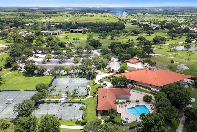 drone / aerial view with golf course view and a water view