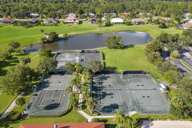drone / aerial view with a residential view, view of golf course, and a water view