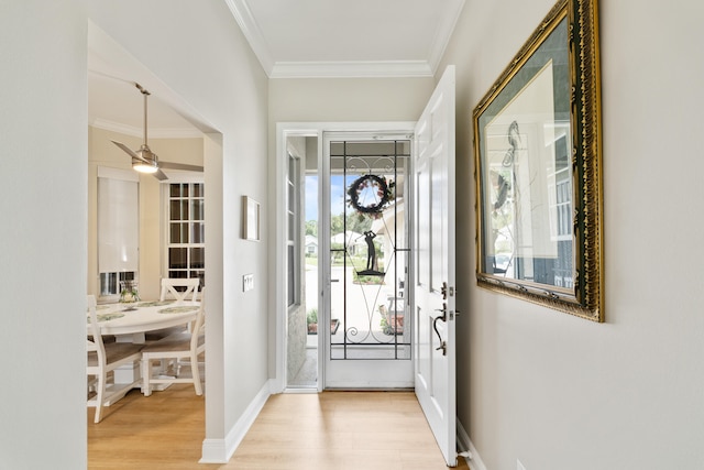 entryway with light hardwood / wood-style flooring and ornamental molding