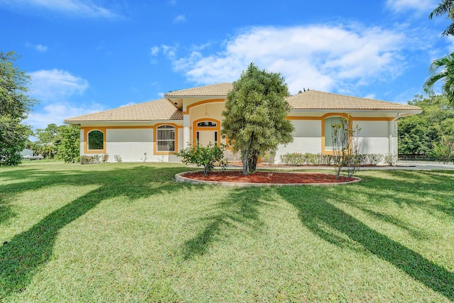 mediterranean / spanish house with a front lawn