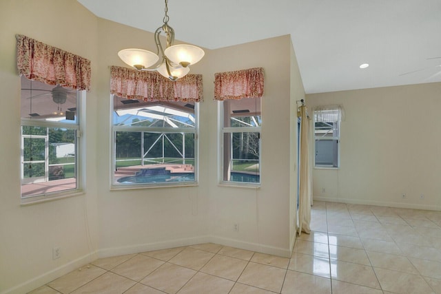 tiled spare room featuring an inviting chandelier and vaulted ceiling