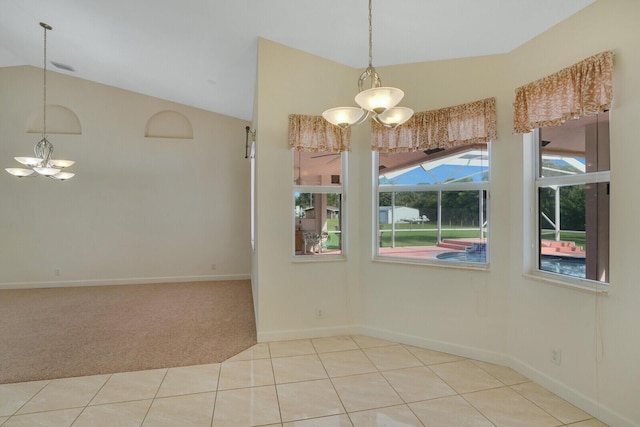 carpeted spare room featuring lofted ceiling and a chandelier