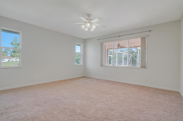 unfurnished room with light colored carpet and ceiling fan