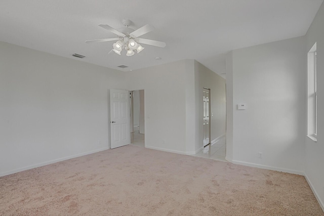 carpeted spare room with ceiling fan