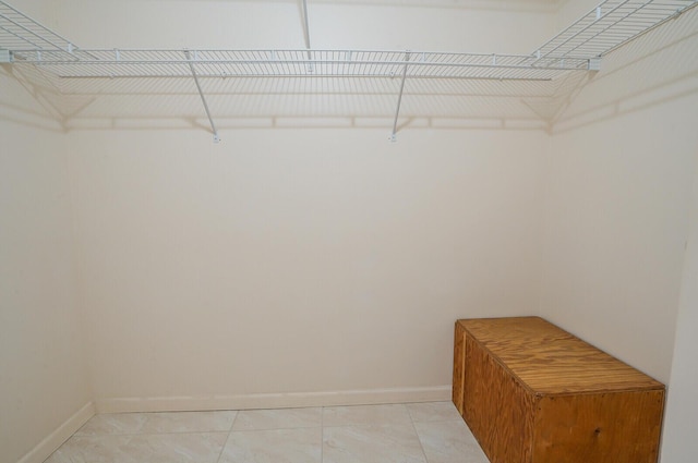 spacious closet featuring light tile patterned flooring