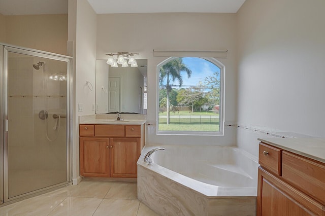 bathroom featuring tile patterned floors, vanity, and shower with separate bathtub