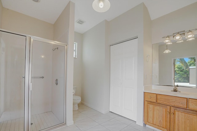 bathroom featuring vanity, tile patterned flooring, plenty of natural light, and toilet