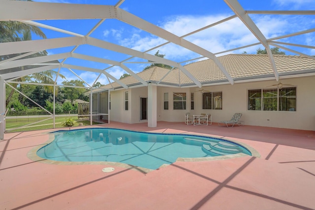 view of swimming pool with a lanai and a patio