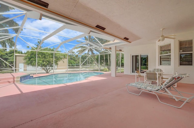 view of pool with a lanai, a patio, and ceiling fan