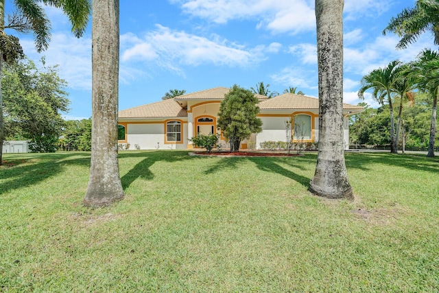 mediterranean / spanish-style house featuring a front yard