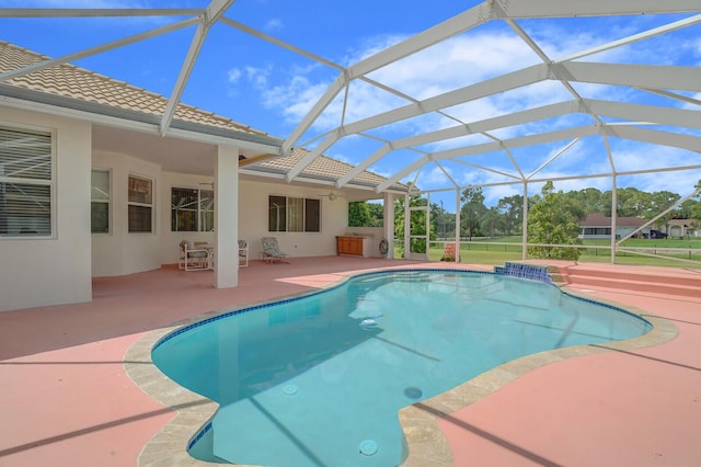 view of pool with glass enclosure and a patio