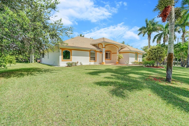 mediterranean / spanish-style house featuring a garage and a front yard