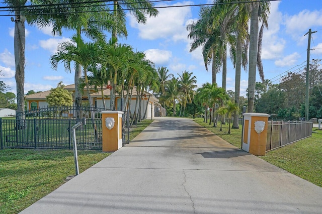 view of gate with a lawn