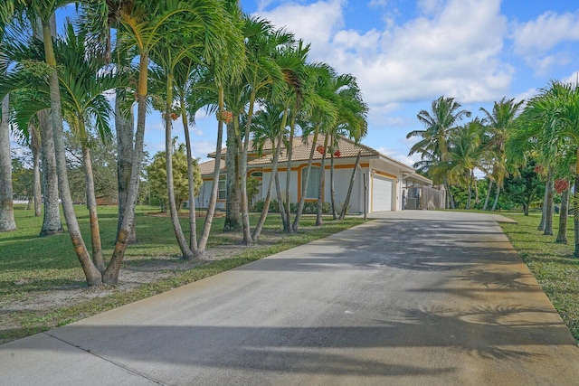 view of front facade with a garage and a front lawn