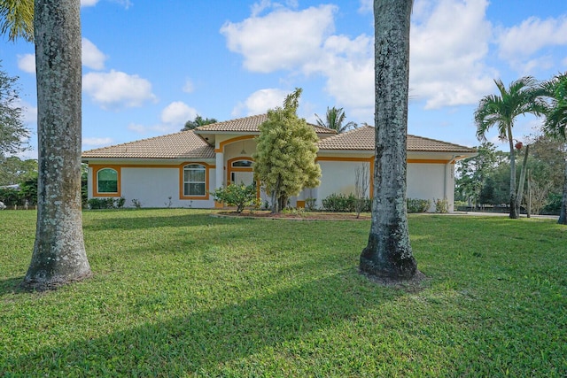 mediterranean / spanish-style house with a front yard