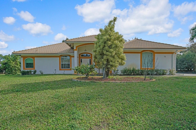 mediterranean / spanish home with a front yard