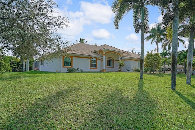 ranch-style home with a front lawn