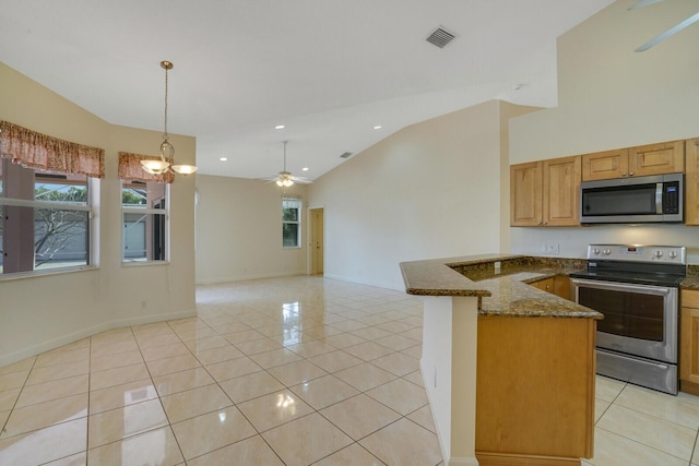 kitchen featuring light tile patterned flooring, hanging light fixtures, appliances with stainless steel finishes, dark stone counters, and ceiling fan with notable chandelier