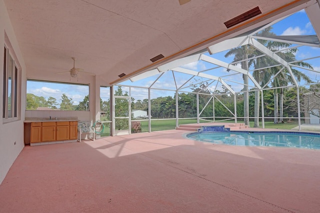 view of swimming pool with a patio area and glass enclosure