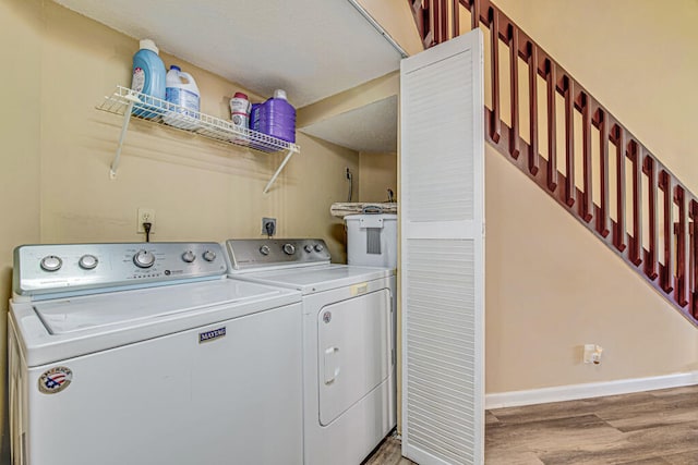 laundry area featuring light hardwood / wood-style floors and independent washer and dryer