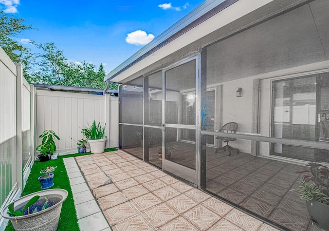 view of patio featuring a sunroom