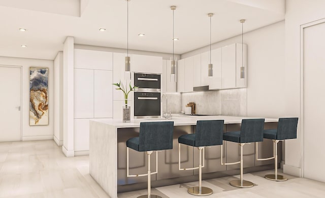 kitchen featuring white cabinetry, sink, decorative light fixtures, a breakfast bar area, and double oven