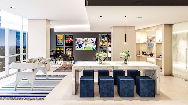 kitchen with a kitchen bar, a center island, expansive windows, and hanging light fixtures