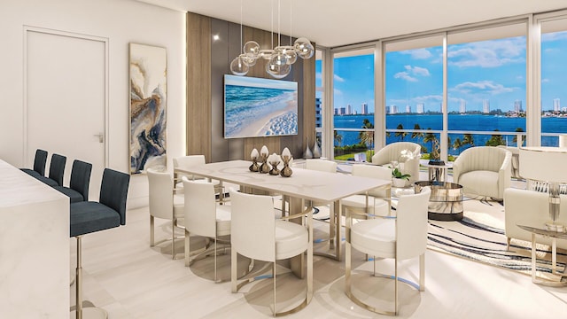 dining room featuring a notable chandelier, a water view, and expansive windows