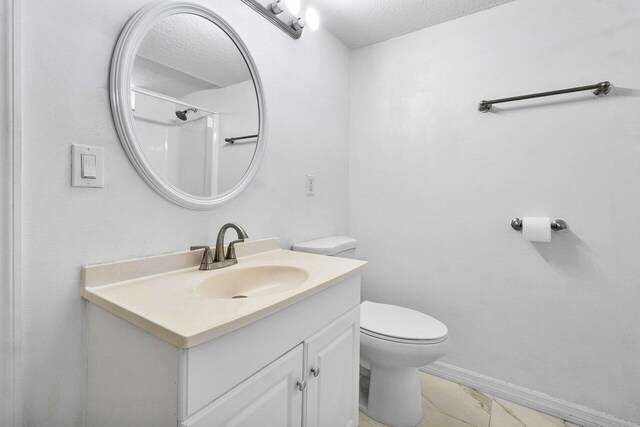 bathroom featuring toilet, a textured ceiling, a shower, and vanity