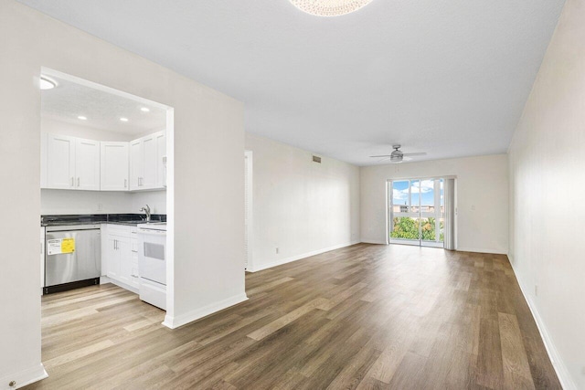 interior space featuring ceiling fan, sink, and hardwood / wood-style flooring